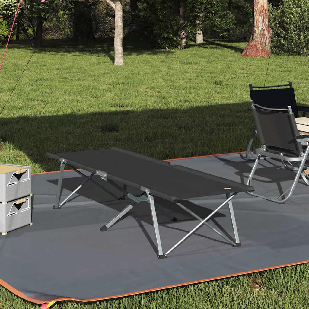 Folding black portable camping cot set up outdoors